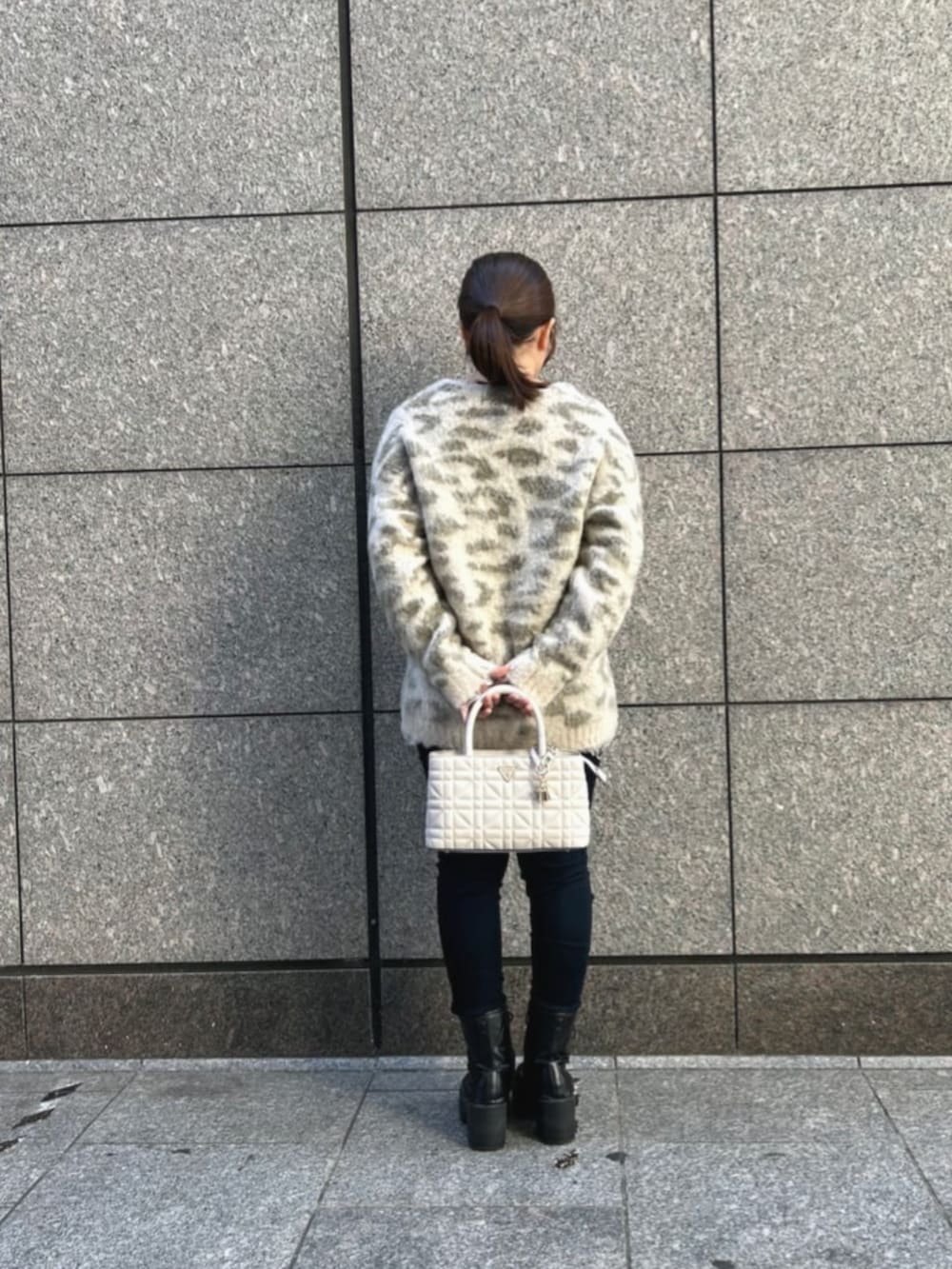 ブルー系のデニムパンツ、ホワイト系のショルダーバッグ、その他のカーディガン/ボレロを着用したレディースの秋コーディネートの2枚目の写真