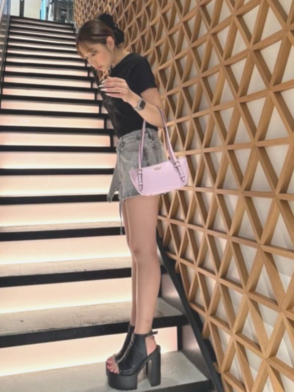 パープル系のショルダーバッグ、グレー系のデニムパンツを着用したレディースの夏コーディネートの3枚目の写真