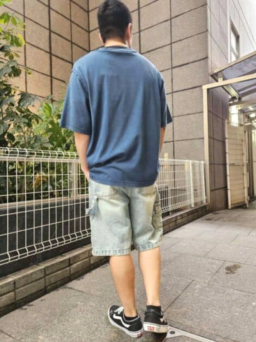 ブルー系のTシャツ/カットソー、ブルー系のデニムパンツ、ブラック系のキャップを着用したメンズの夏コーディネートの2枚目の写真