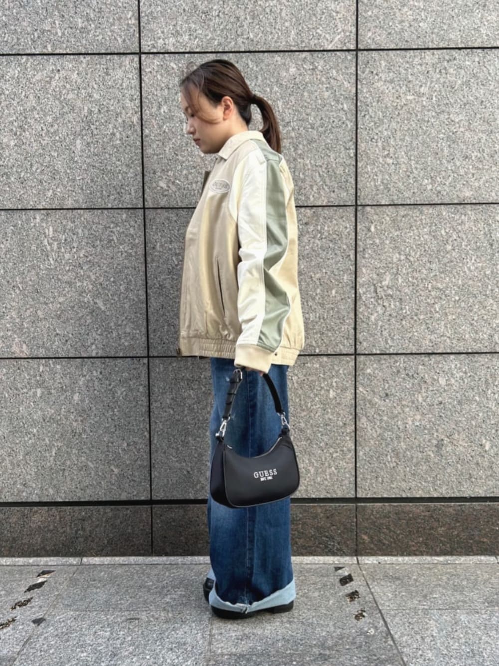 ベージュ系のその他アウター、ブルー系のデニムパンツ、ブラック系のショルダーバッグを着用したレディースの秋コーディネートの3枚目の写真