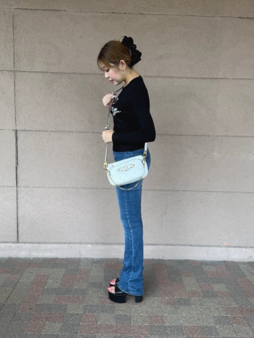 ホワイト系のショルダーバッグ、ブラック系のTシャツ/カットソーを着用したレディースの秋コーディネートの3枚目の写真