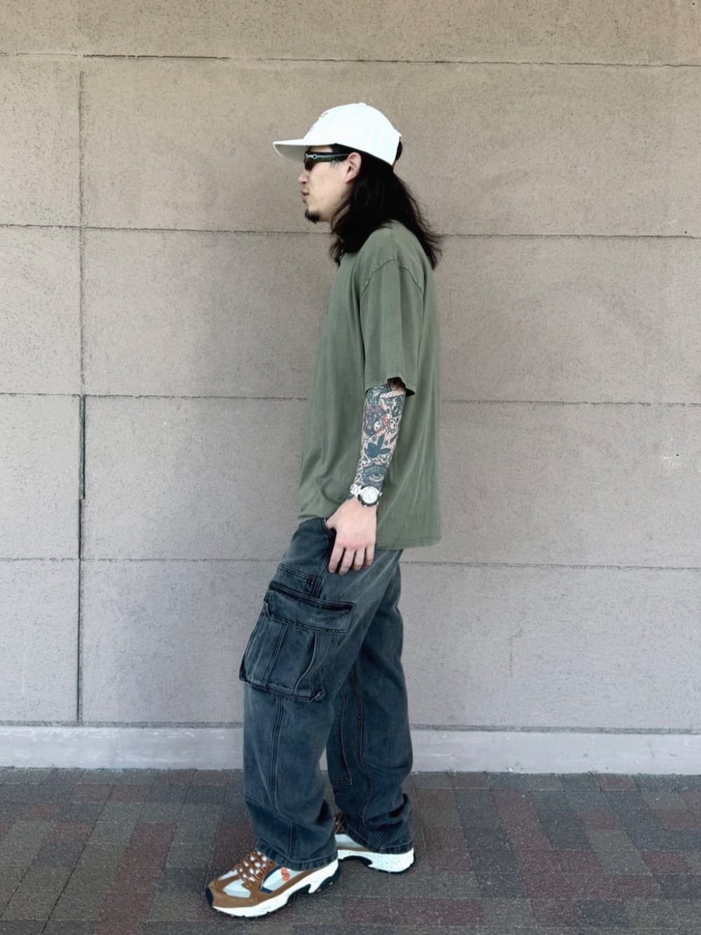 グリーン系のTシャツ/カットソー、ブラック系のデニムパンツを着用したメンズの夏コーディネートの3枚目の写真