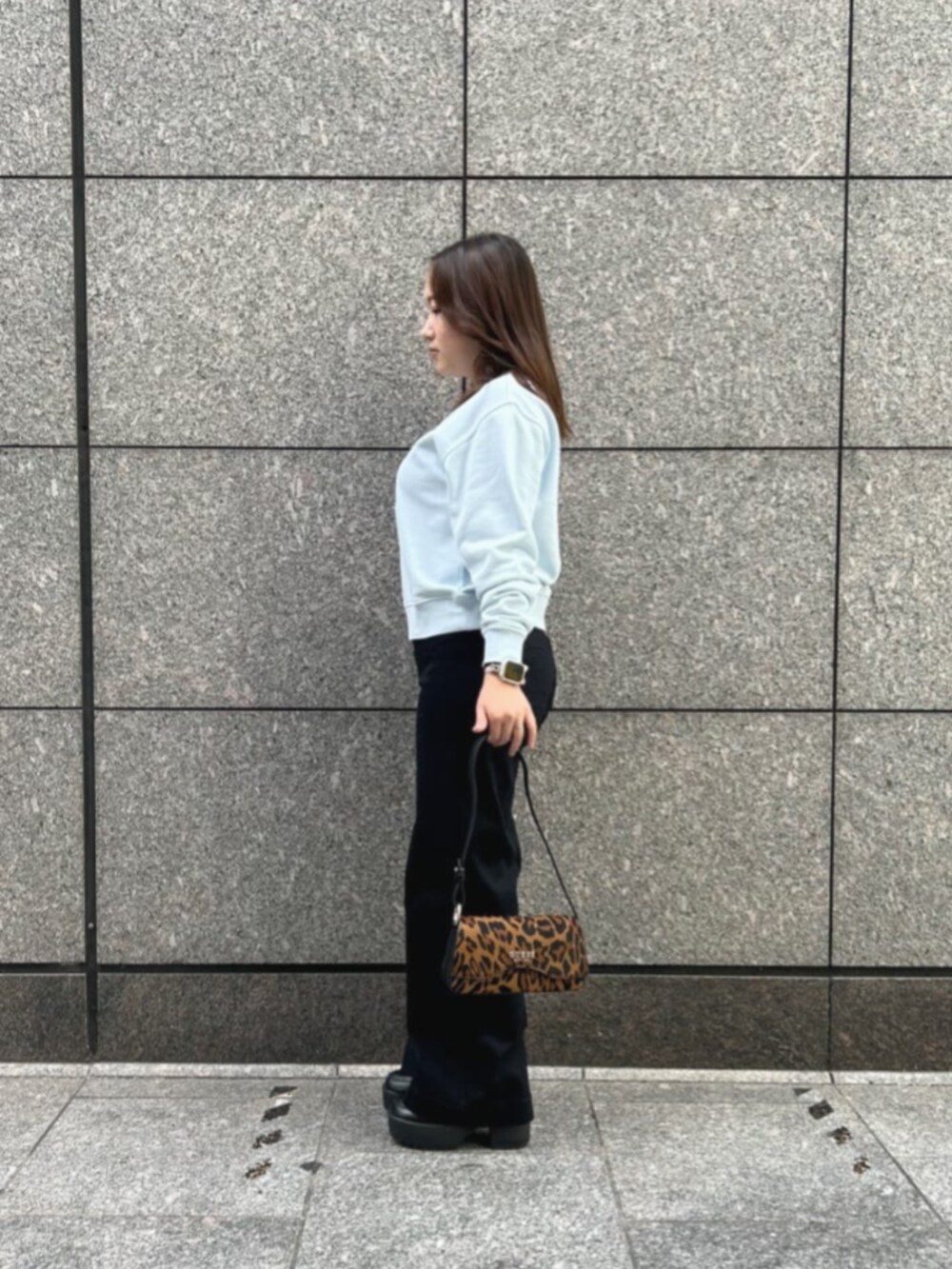 ブラック系のデニムパンツ、ブルー系のスウェット、その他のハンドバッグを着用したレディースの冬コーディネートの3枚目の写真