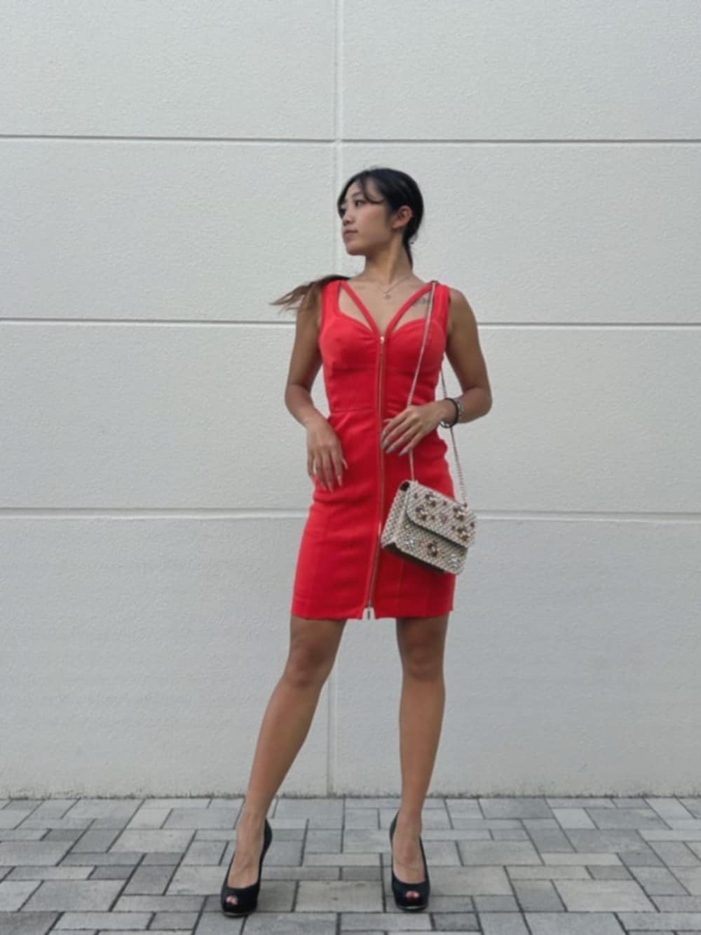 オレンジ系のドレス、ブラウン系のショルダーバッグを着用したレディースの秋コーディネートの4枚目の写真