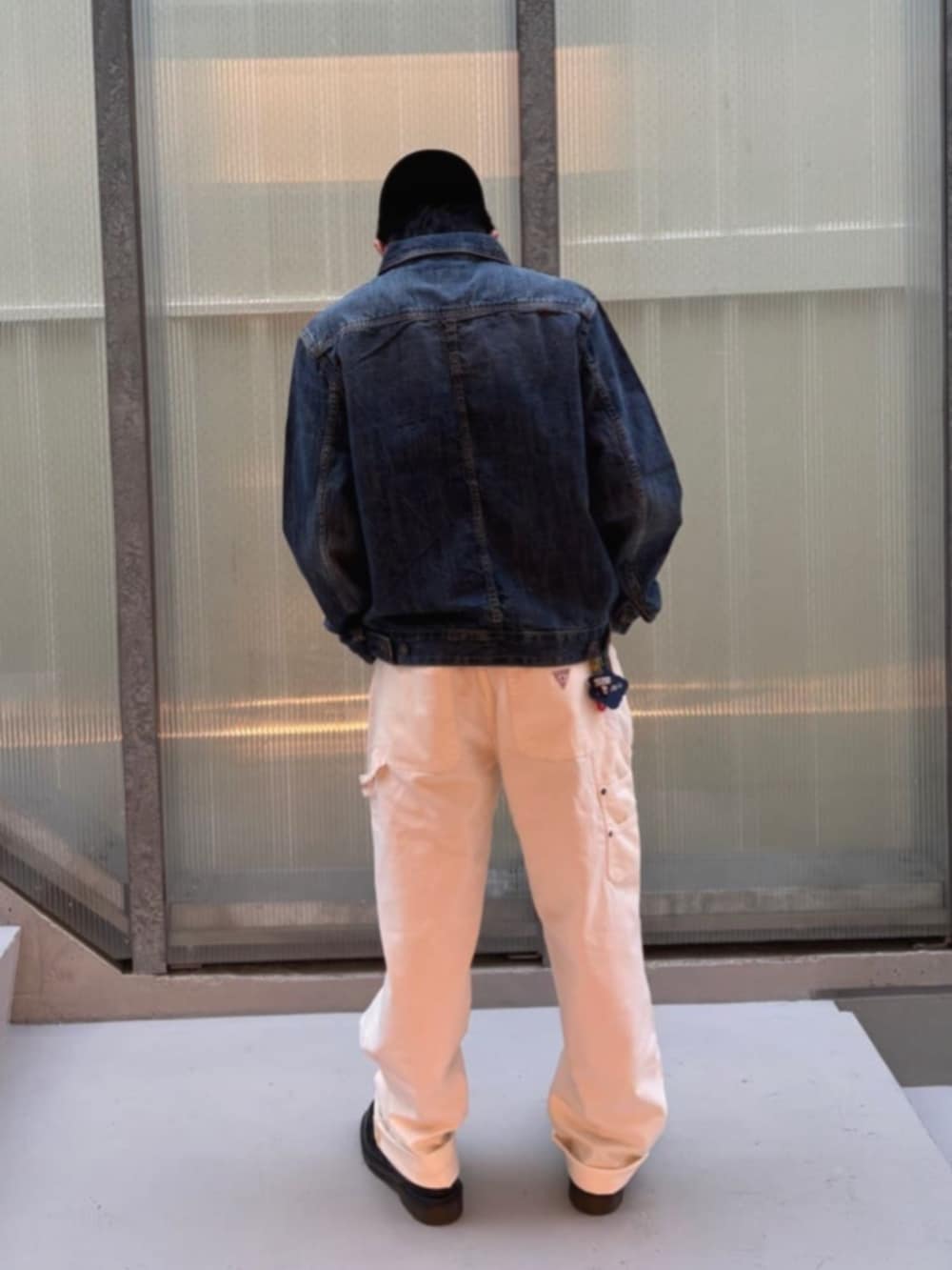 ホワイト系のカーゴパンツ、ブルー系のデニムジャケット、ホワイト系のTシャツ/カットソーを着用したメンズの秋コーディネートの2枚目の写真