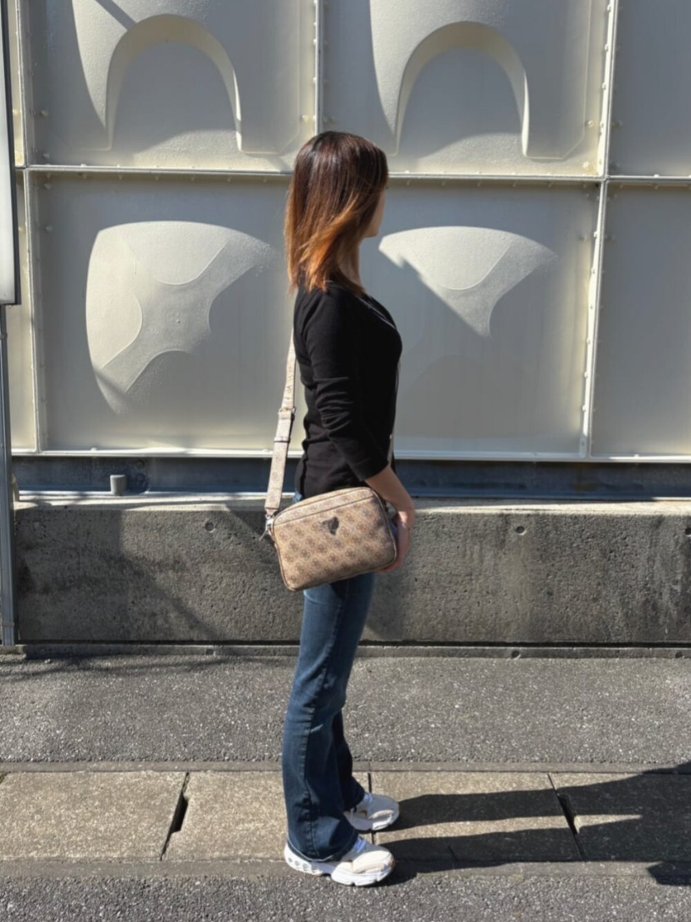 ベージュ系のショルダーバッグを着用したレディースの秋コーディネートの3枚目の写真