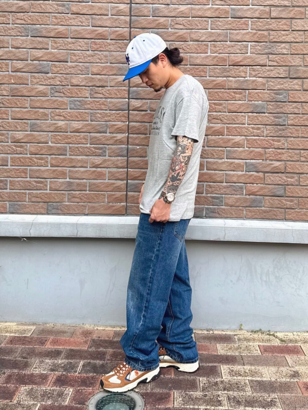 ブルー系のデニムパンツ、グレー系のTシャツ/カットソーを着用したメンズの夏コーディネートの3枚目の写真