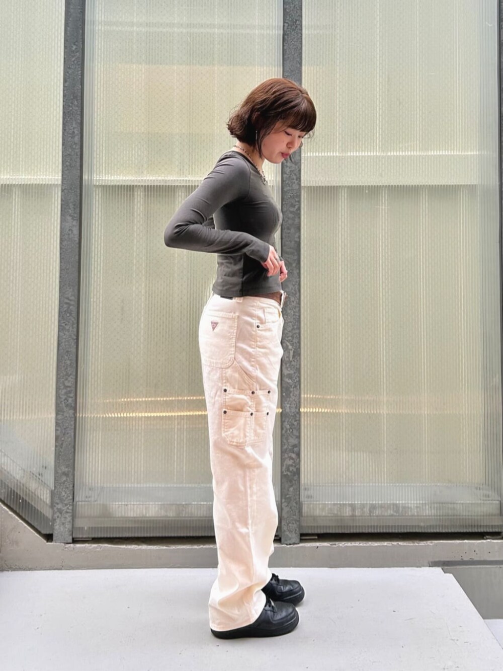 ブラック系のTシャツ/カットソー、ホワイト系のカーゴパンツを着用したレディースの夏コーディネートの3枚目の写真