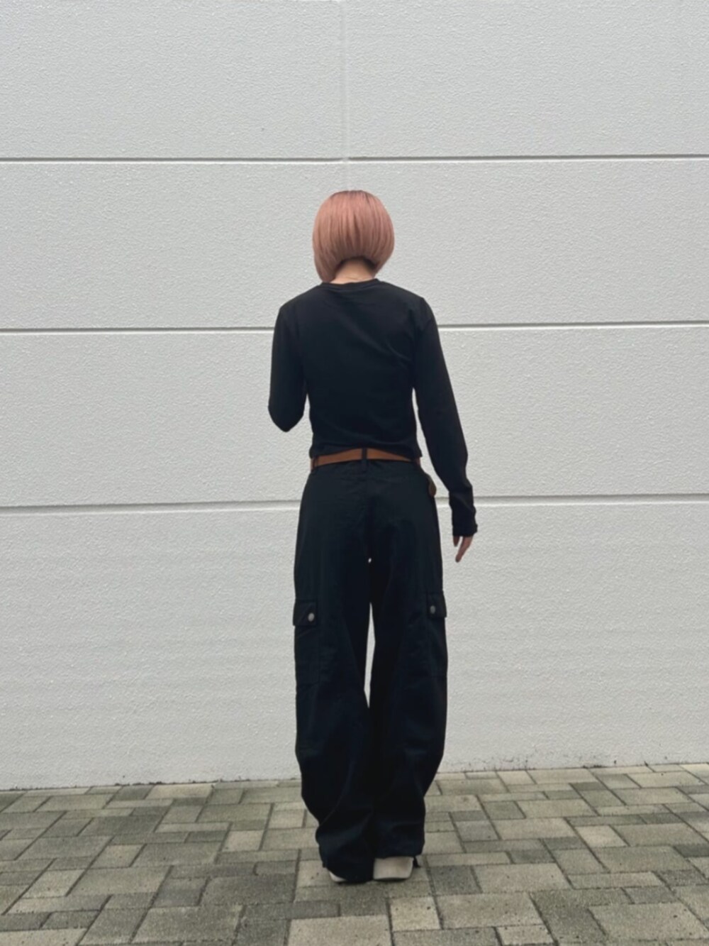 ブラック系のカーゴパンツ、ブラック系のTシャツ/カットソーを着用したレディースの秋コーディネートの2枚目の写真