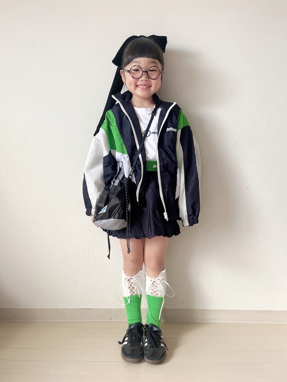 ブルー系のブルゾン、ブルー系のスカート、ホワイト系のTシャツ/カットソーを着用したキッズの冬コーディネートの2枚目の写真