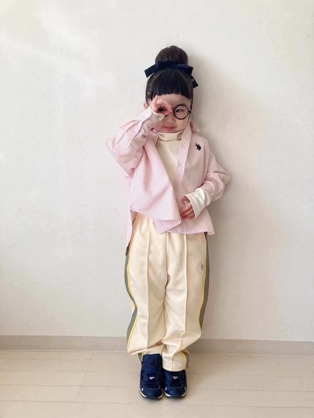 イエロー系のその他パンツ、オレンジ系のシャツ/ブラウス、ホワイト系のTシャツ/カットソーを着用したキッズの冬コーディネートの2枚目の写真