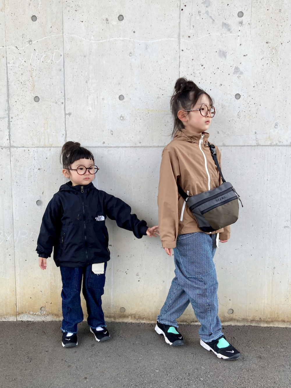 ブルー系のサロペット/オーバーオール、ホワイト系のサロペット/オーバーオール、グリーン系のナイロンジャケットを着用したキッズの春コーディネートの2枚目の写真