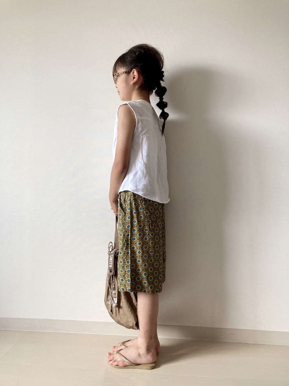 ベージュ系のその他パンツ、ホワイト系のシャツ/ブラウス、ベージュ系のビーチサンダルを着用したキッズの夏コーディネートの2枚目の写真