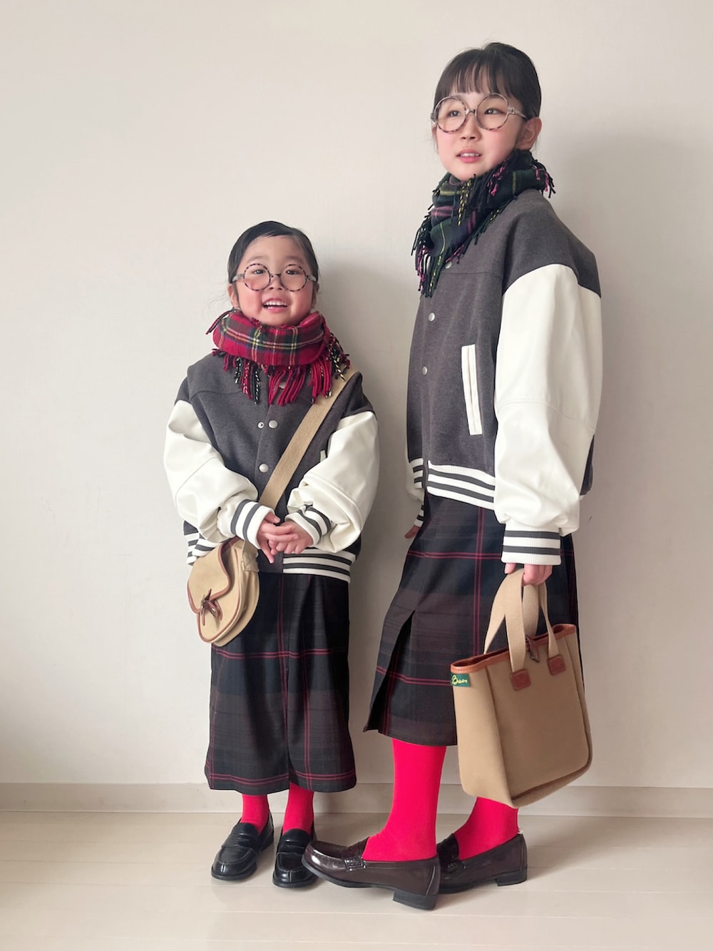 グレー系のスタジャン、グレー系のスタジャン、ホワイト系のニット/セーターを着用したキッズの冬コーディネートの2枚目の写真