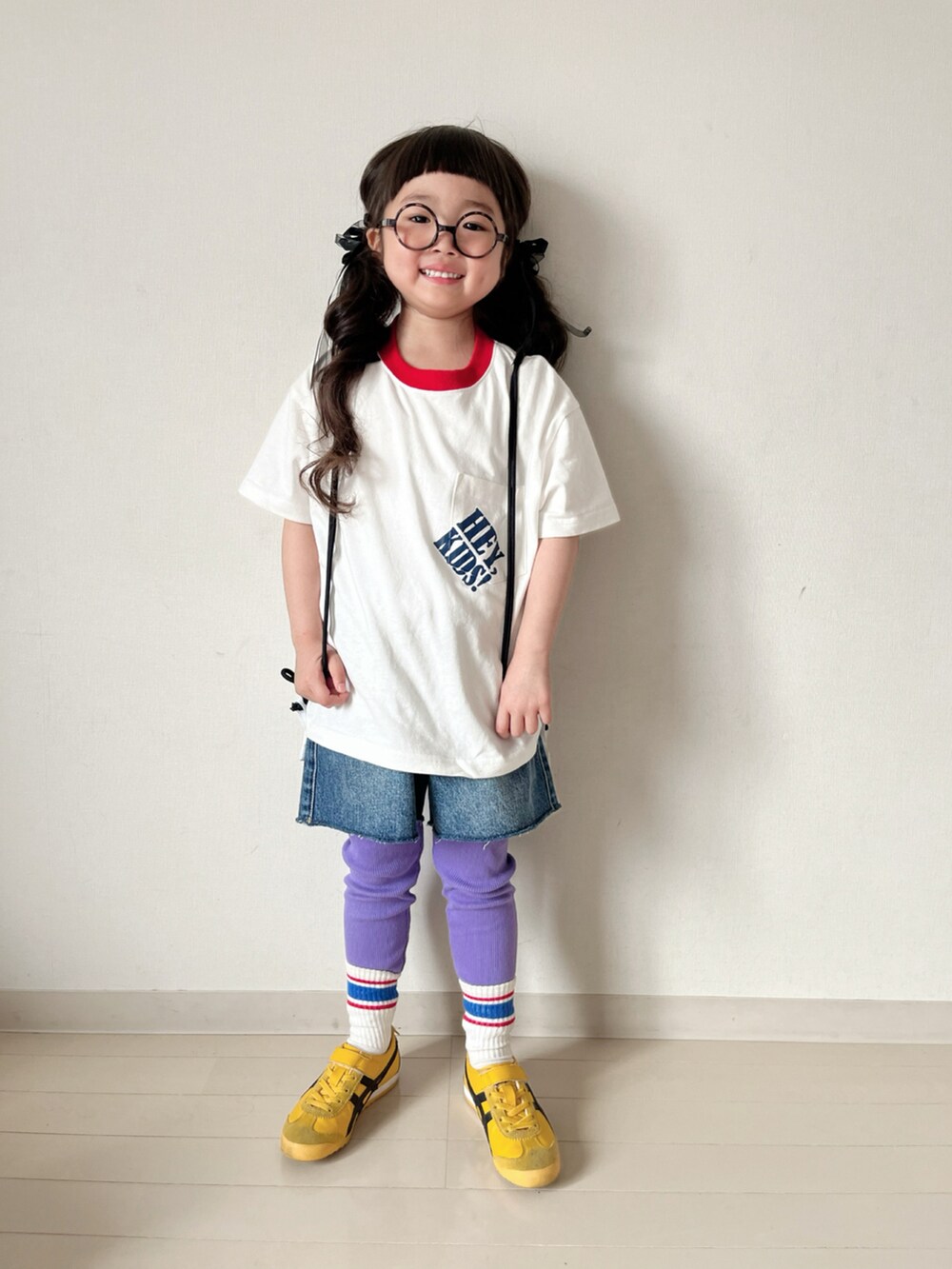 ホワイト系のTシャツ/カットソー、ホワイト系のバックパック/リュック、イエロー系のスニーカーを着用したキッズの春コーディネートの4枚目の写真