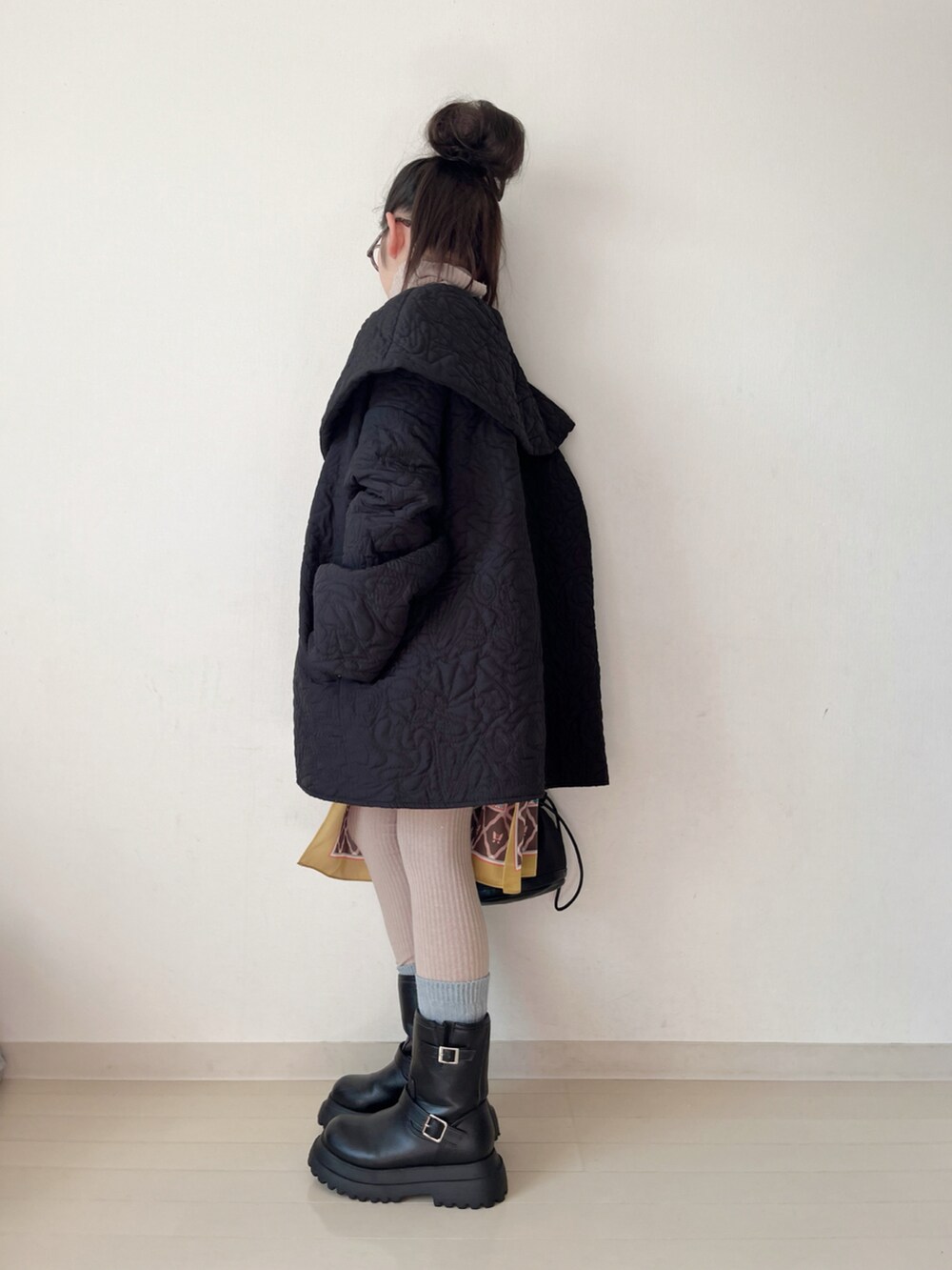 ブラック系のブーツ、ブラック系のその他パンツ、ベージュ系のニット/セーターを着用したキッズの冬コーディネートの5枚目の写真