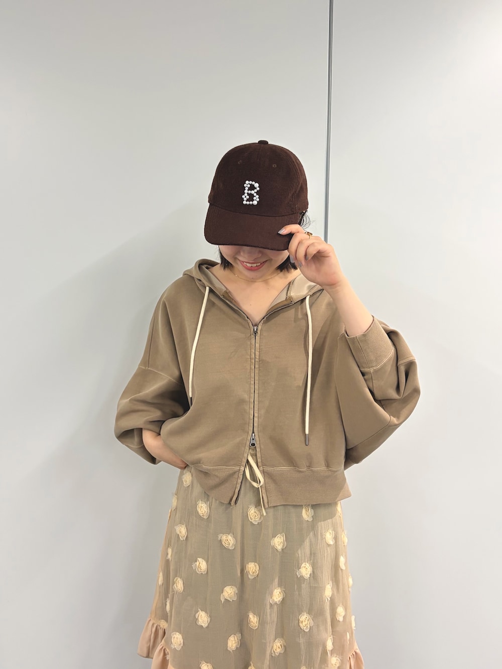 ベージュ系のパーカー、ベージュ系のスカート、グリーン系のその他パンツを着用したレディースの秋コーディネートの3枚目の写真