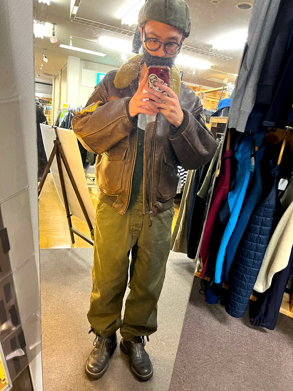 ブラウン系のミリタリージャケットを着用したメンズの冬コーディネートの2枚目の写真