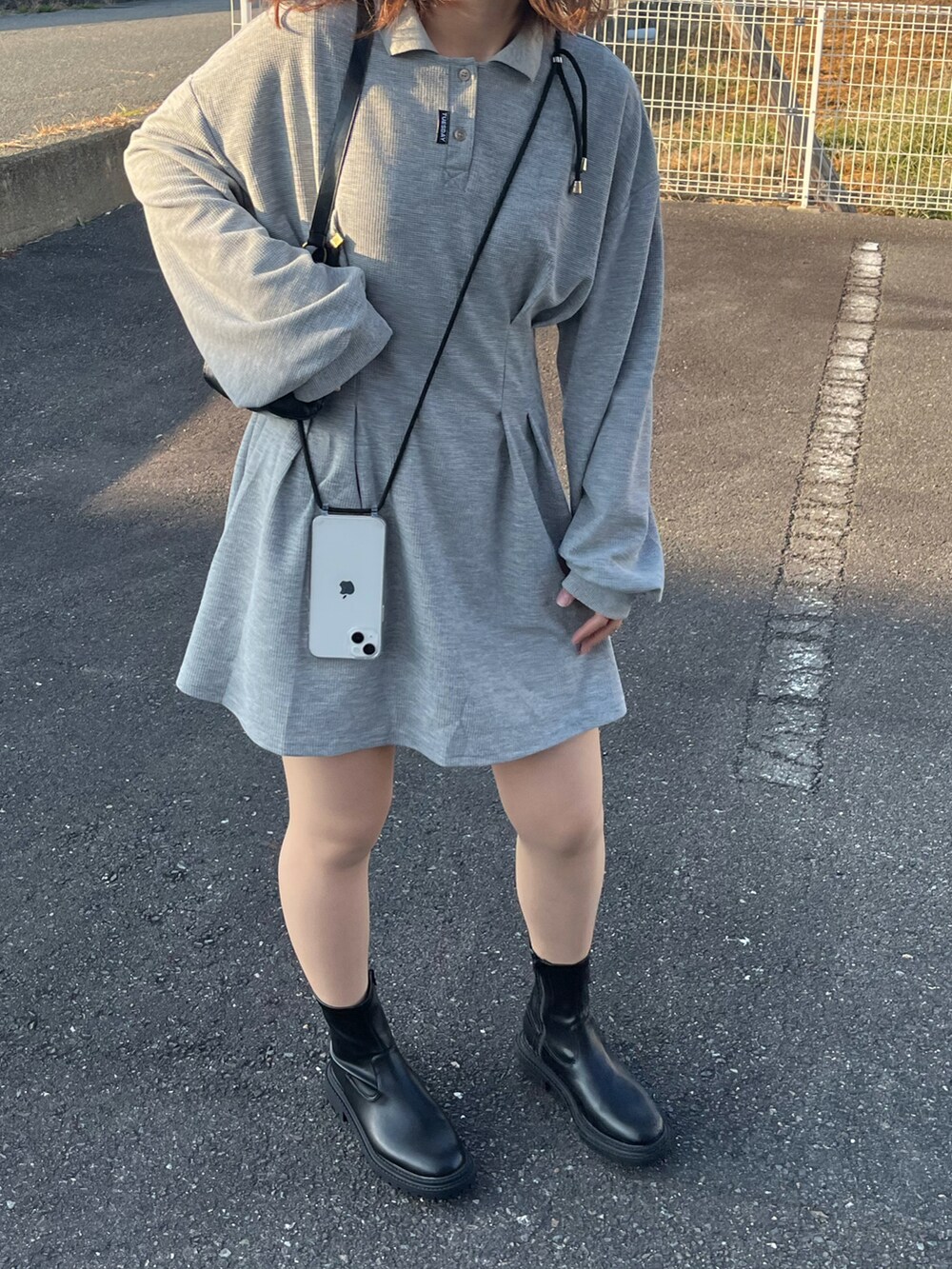 グレー系のワンピース/ドレス、ブラック系のショルダーバッグ、ブラック系のブーツを着用したレディースの秋コーディネートの2枚目の写真