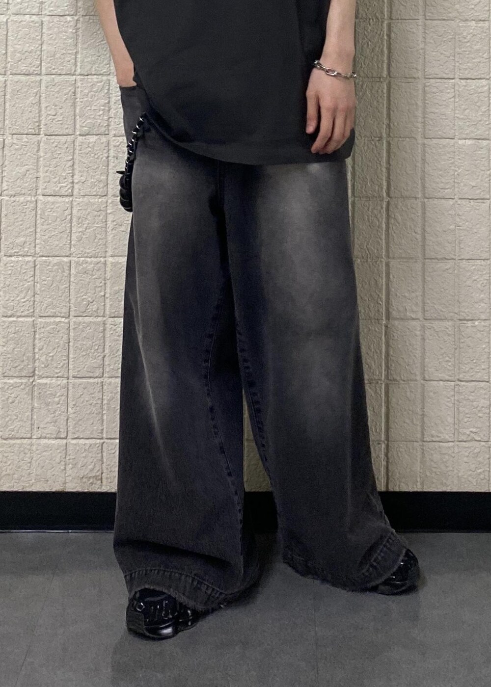 ブラック系のTシャツ/カットソー、ブラック系のデニムパンツを着用したメンズの夏コーディネートの6枚目の写真