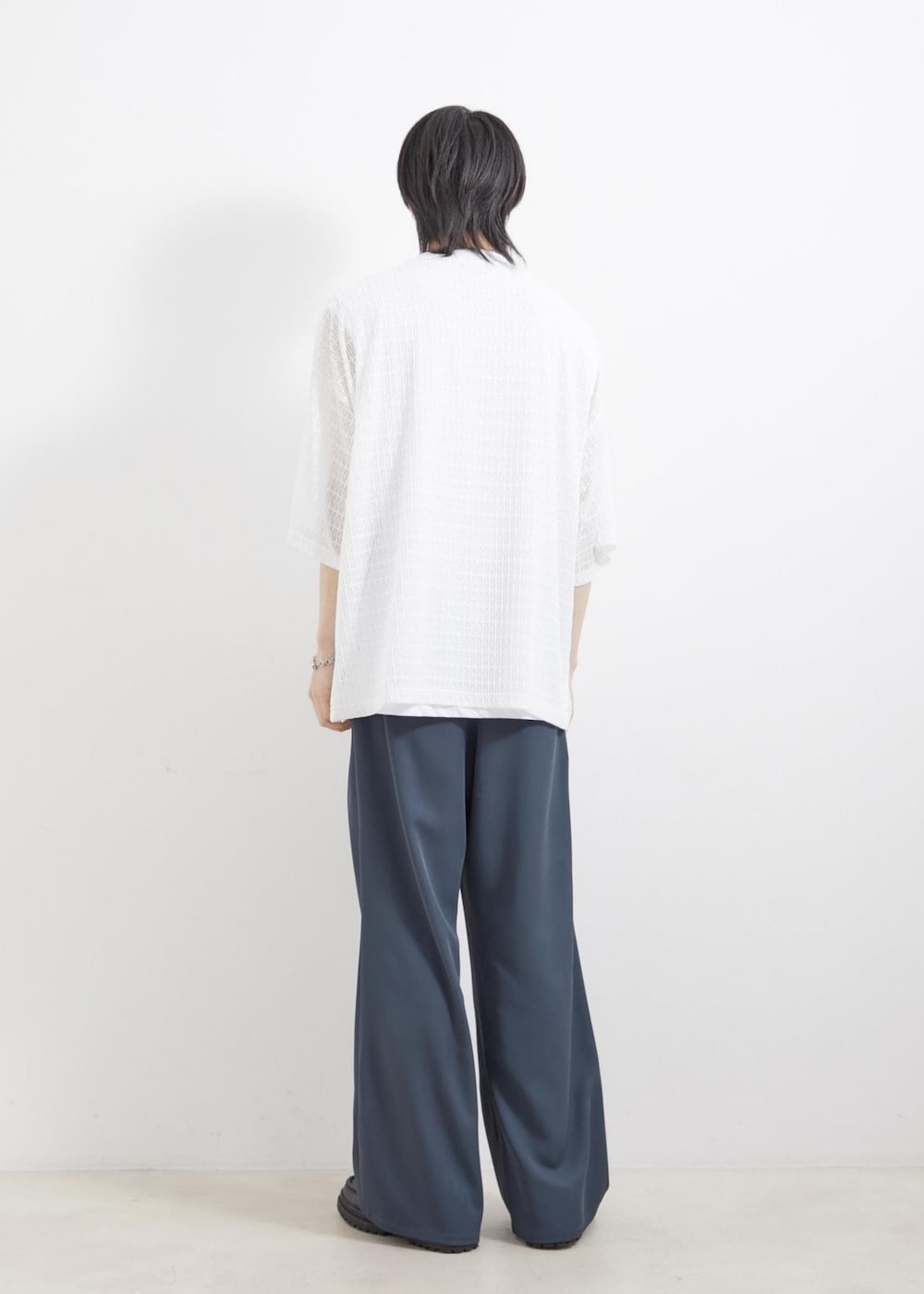 ブラック系のローファー、グリーン系のスラックス、ホワイト系のアンサンブルを着用したメンズの夏コーディネートの3枚目の写真