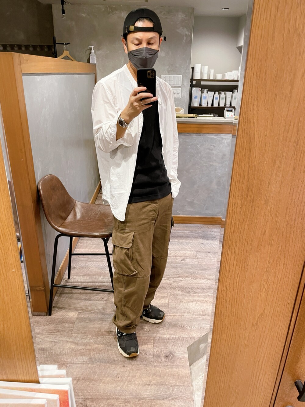 ブラック系のスニーカー、ブラウン系のカーゴパンツ、ホワイト系のシャツ/ブラウスを着用したメンズの秋コーディネートの3枚目の写真