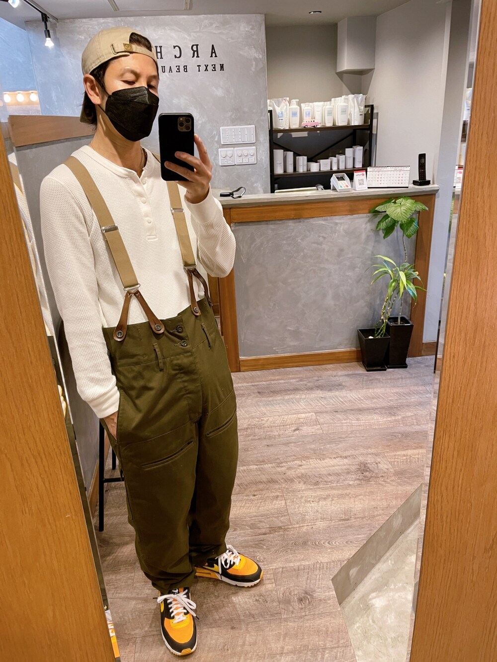 グリーン系のカーゴパンツ、オレンジ系のスニーカー、ホワイト系のTシャツ/カットソーを着用したメンズの冬コーディネートの2枚目の写真