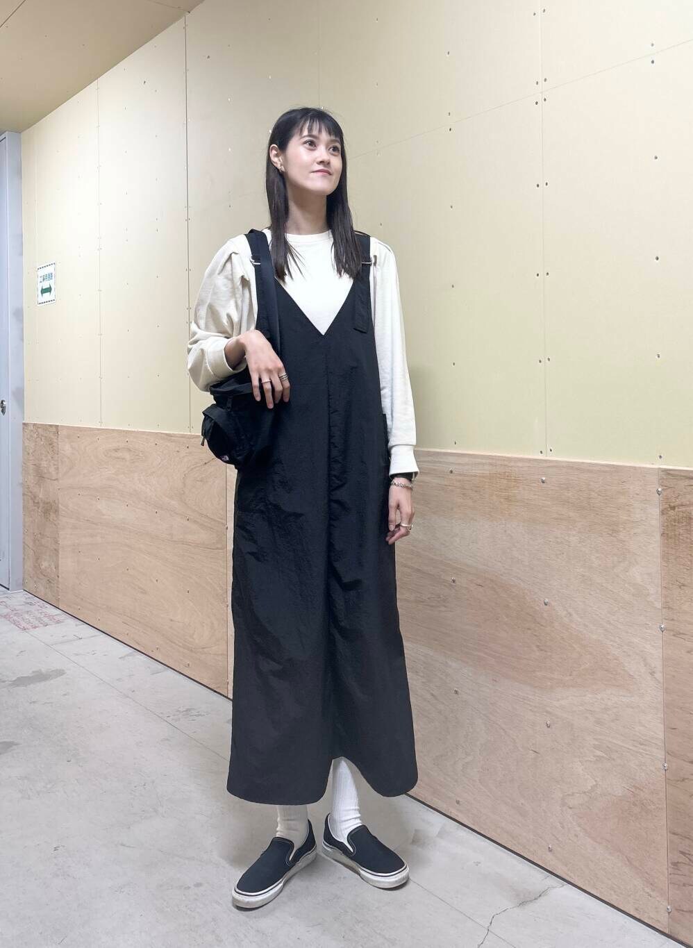 グリーン系のベスト、ブラック系のワンピース、ベージュ系のTシャツ/カットソーを着用したレディースの秋コーディネートの5枚目の写真