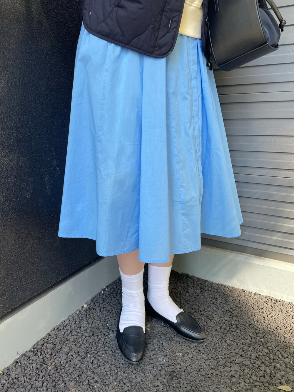 ブルー系のダウンジャケット/コート、ブルー系のワンピース、ホワイト系のスウェットを着用したレディースの冬コーディネートの3枚目の写真