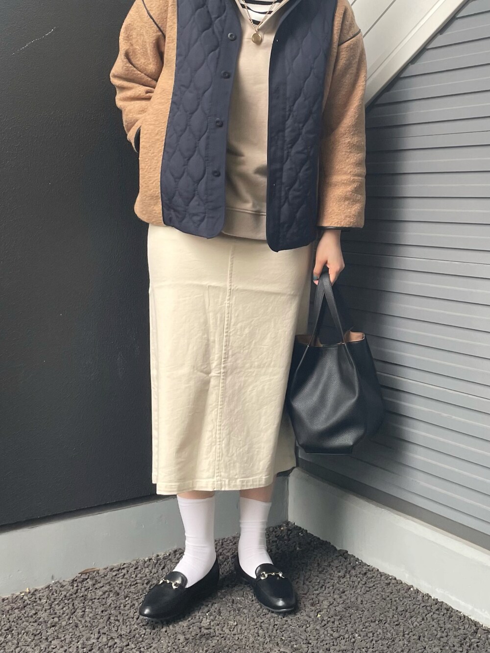 ブラウン系のブルゾン、ベージュ系のパーカー、ブラック系のTシャツ/カットソーを着用したレディースの冬コーディネートの2枚目の写真