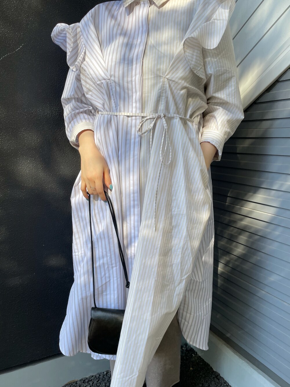 ベージュ系のワンピース、ブラック系のショルダーバッグ、グレー系のその他パンツを着用したレディースの冬コーディネートの3枚目の写真