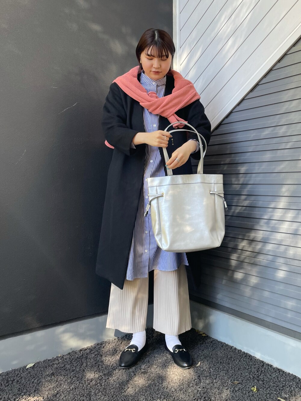 シルバー系のトートバッグ、ブラック系のその他アウター、ブルー系のワンピース/ドレスを着用したレディースの冬コーディネートの2枚目の写真