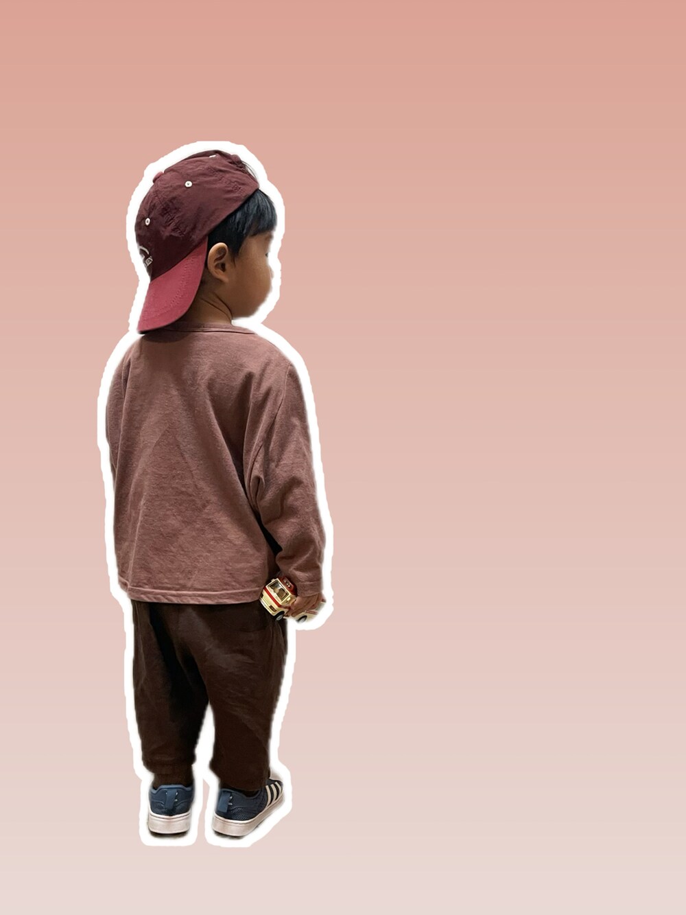 レッド系のキャップを着用したキッズの冬コーディネートの2枚目の写真