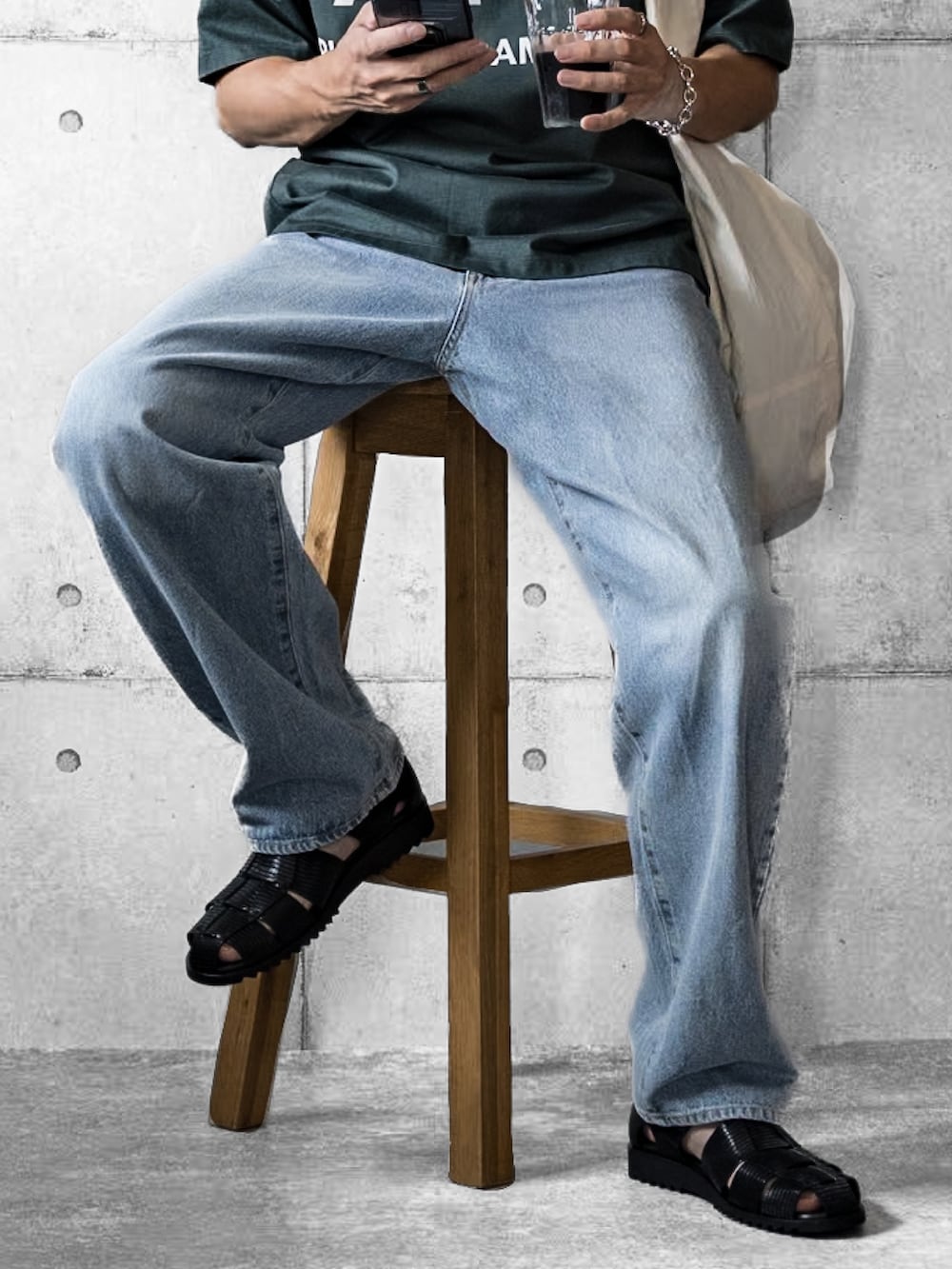 ブルー系のデニムパンツ、ホワイト系のショルダーバッグ、グリーン系のTシャツ/カットソーを着用したメンズの夏コーディネートの3枚目の写真