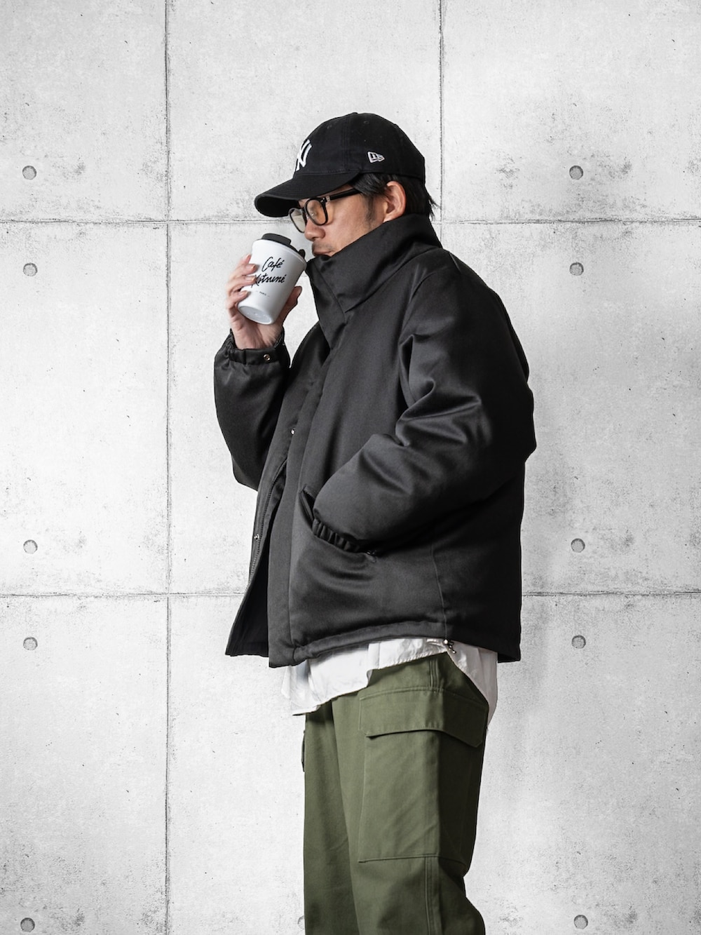 ブラック系のスニーカー、ブラック系のダウンジャケット/コート、グリーン系のカーゴパンツを着用したメンズの冬コーディネートの2枚目の写真