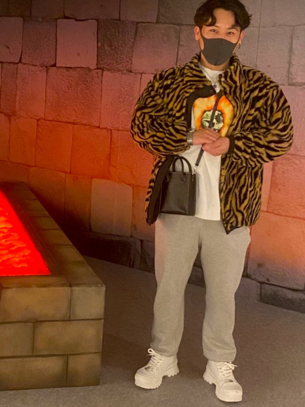 ホワイト系のスニーカー、ブラック系のショルダーバッグ、ブラック系のブルゾンを着用したメンズの春コーディネートの2枚目の写真