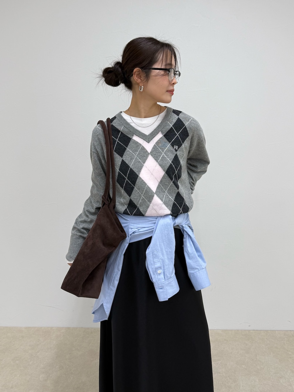 グレー系のニット/セーター、ブラック系のスカートを着用したレディースの冬コーディネートの5枚目の写真