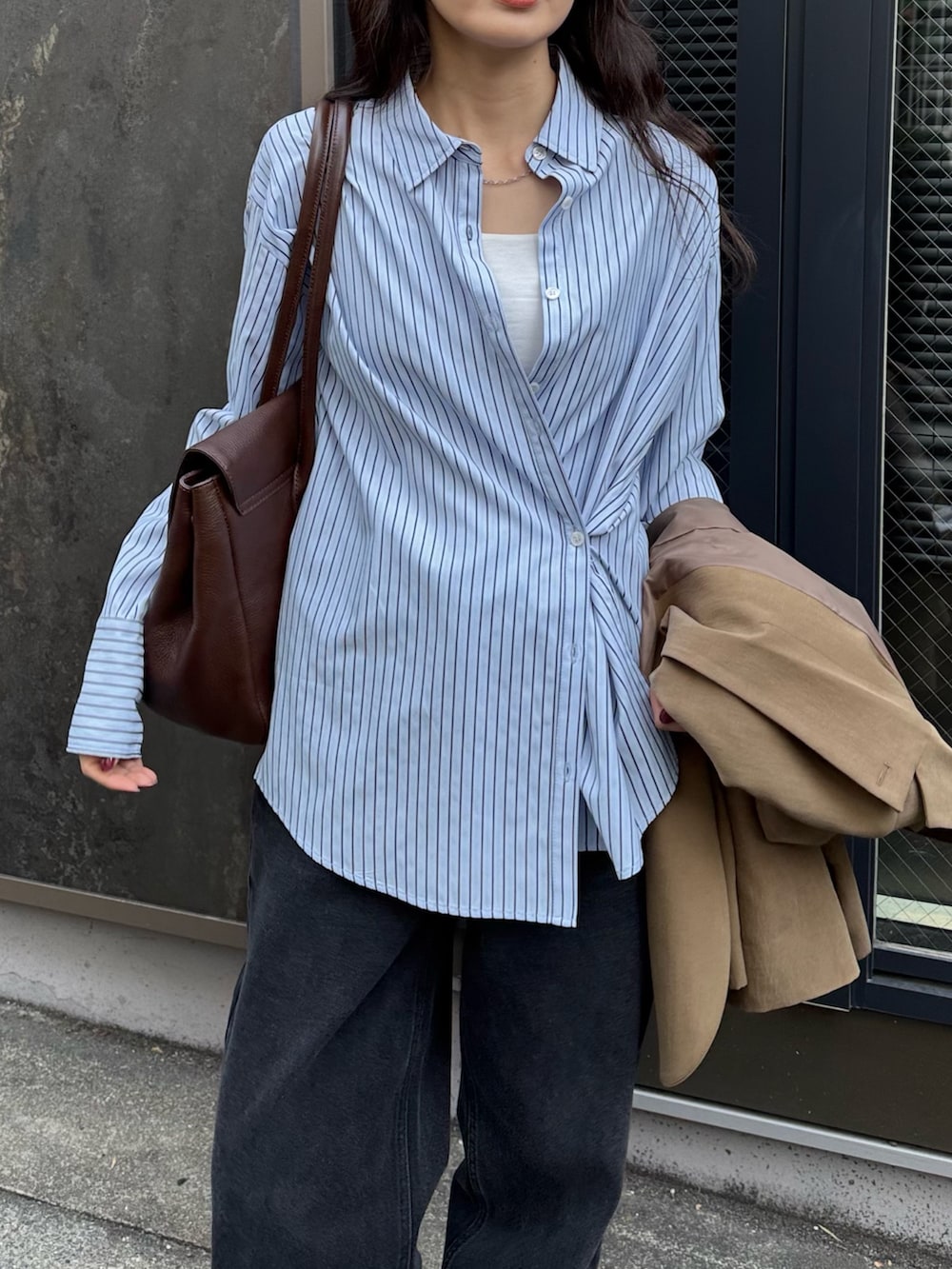 ブラウン系のテーラードジャケット、ブルー系のシャツ/ブラウス、ブラック系のデニムパンツを着用したレディースの冬コーディネートの6枚目の写真