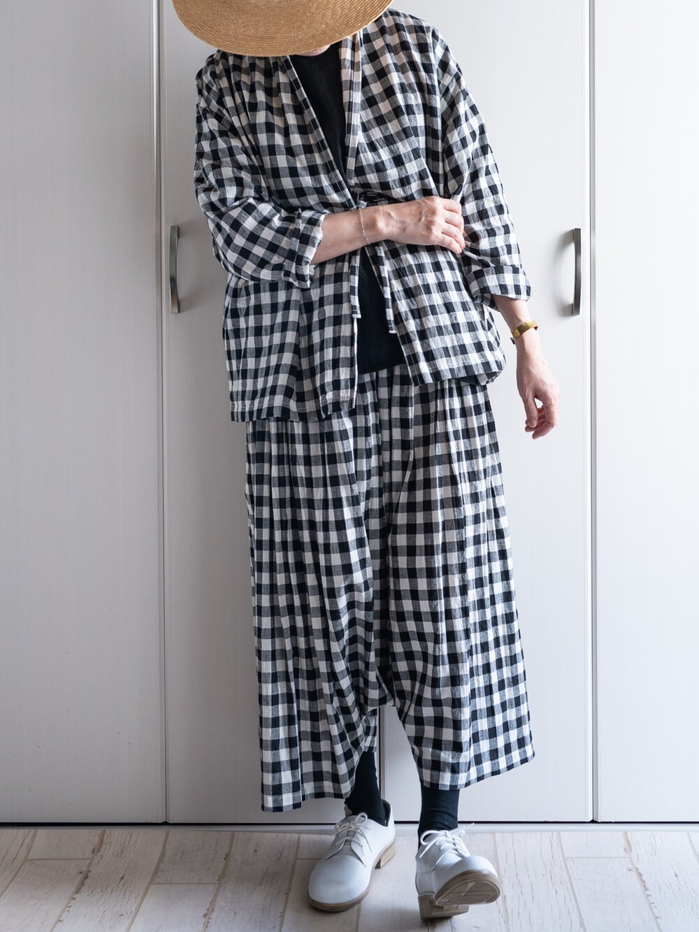 ホワイト系のドレスシューズ、ブラック系のシャツ/ブラウス、ブラック系のその他パンツを着用したレディースの秋コーディネートの2枚目の写真