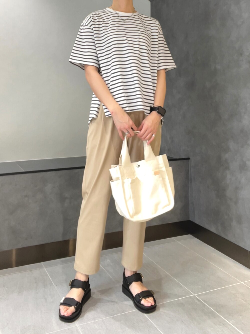 ピンク系のマウンテンパーカー、ホワイト系のTシャツ/カットソー、ブラック系のサンダルを着用したレディースの春コーディネートの3枚目の写真