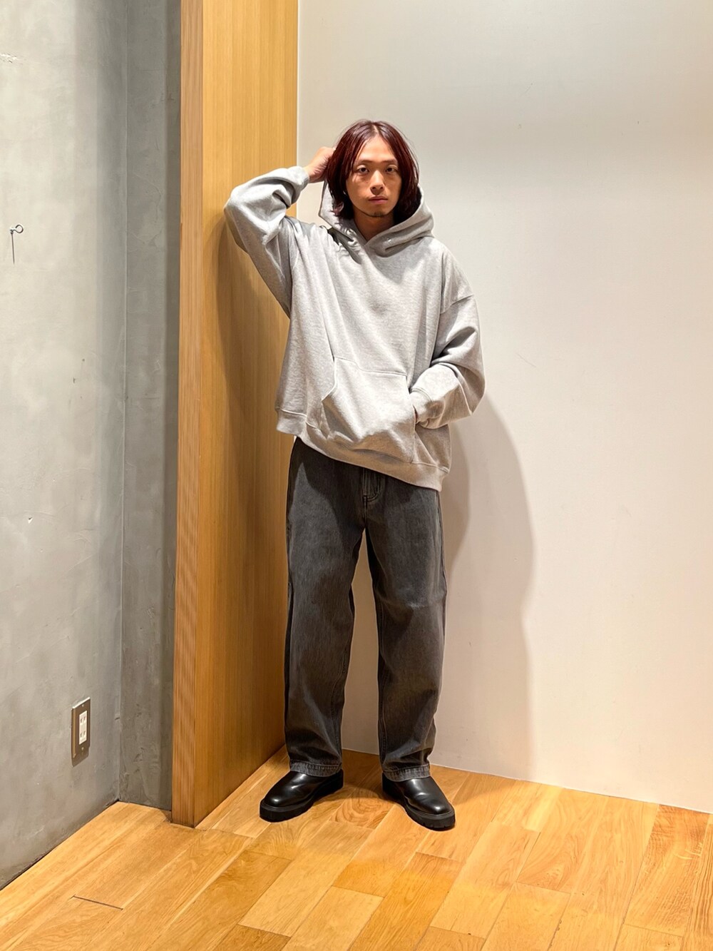 グリーン系のブルゾン、グレー系のパーカー、グレー系のデニムパンツを着用したメンズの秋コーディネートの3枚目の写真