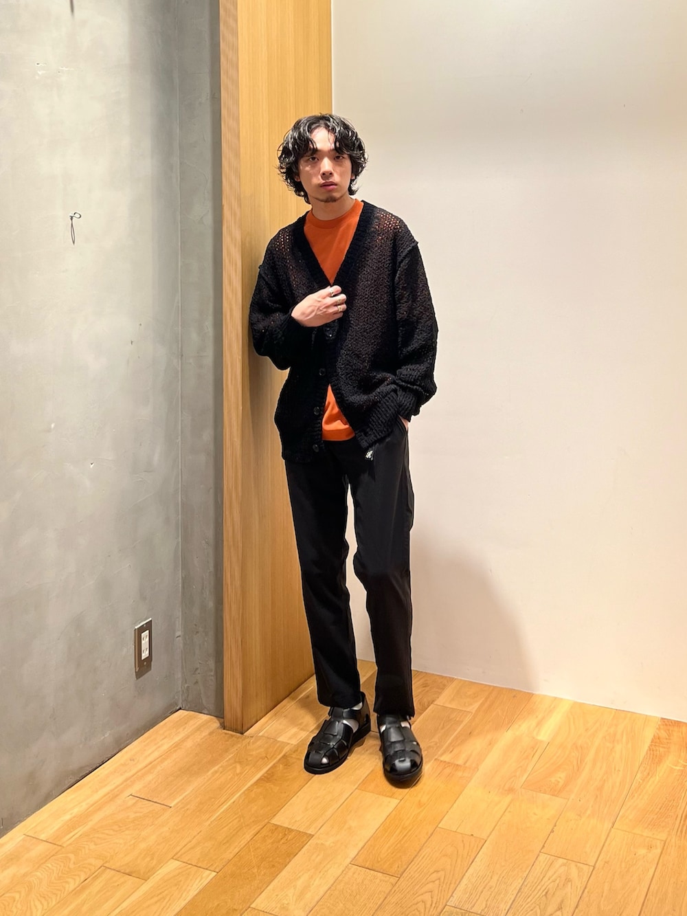 オレンジ系のTシャツ/カットソー、ブラック系のその他パンツ、ブラック系のサンダルを着用したメンズの春コーディネートの5枚目の写真