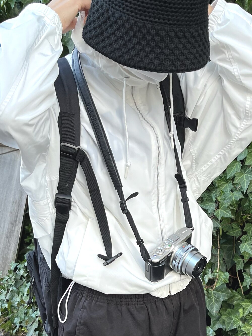 ホワイト系のスニーカー、ブラック系のカーゴパンツを着用したレディースの春コーディネートの3枚目の写真