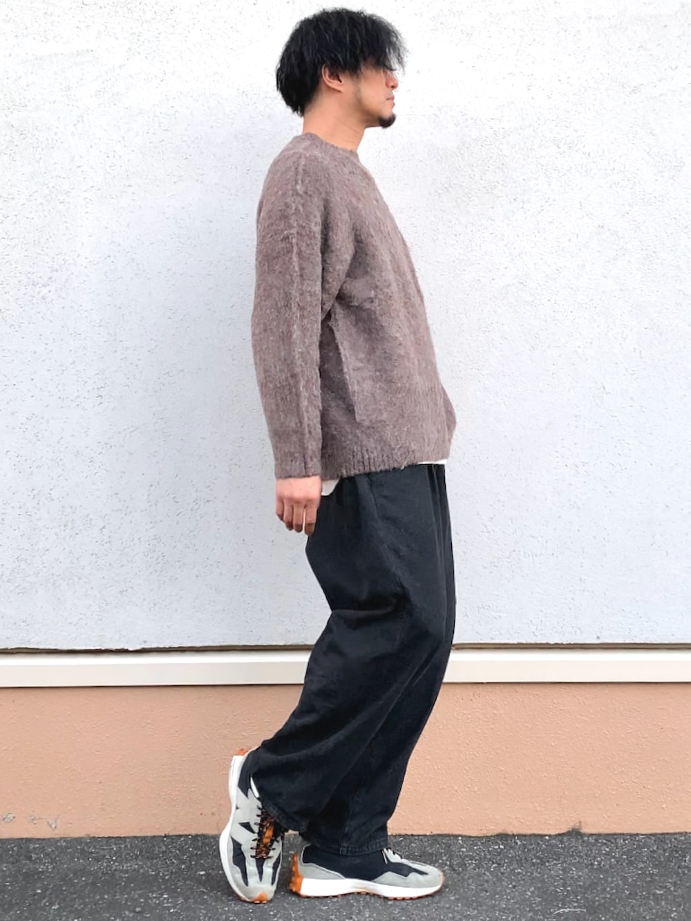 ブラウン系のニット/セーター、ブラック系のデニムパンツを着用したメンズの冬コーディネートの2枚目の写真