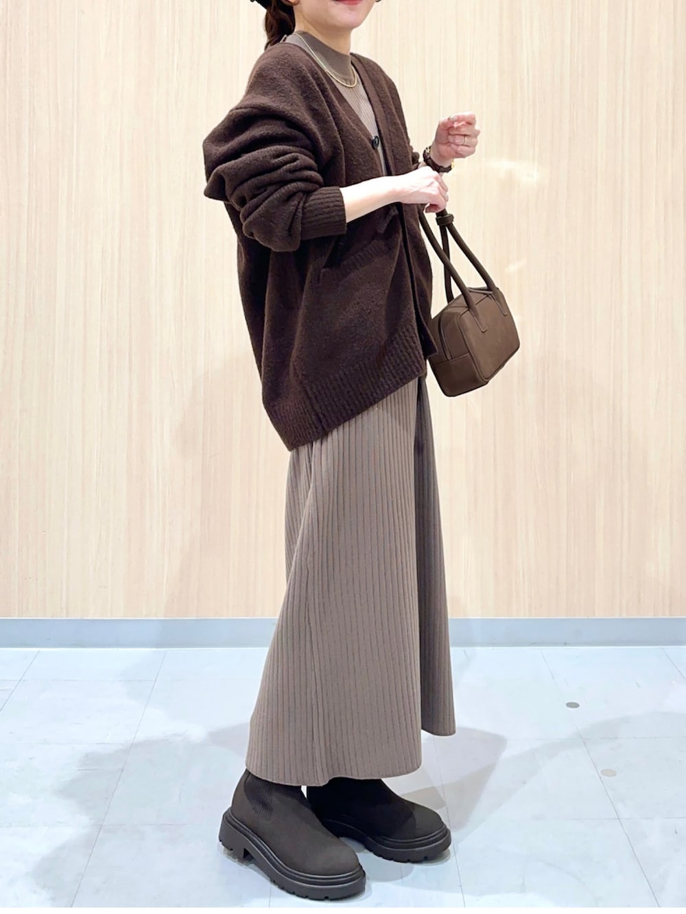 ブラウン系のワンピースを着用したレディースの冬コーディネートの3枚目の写真
