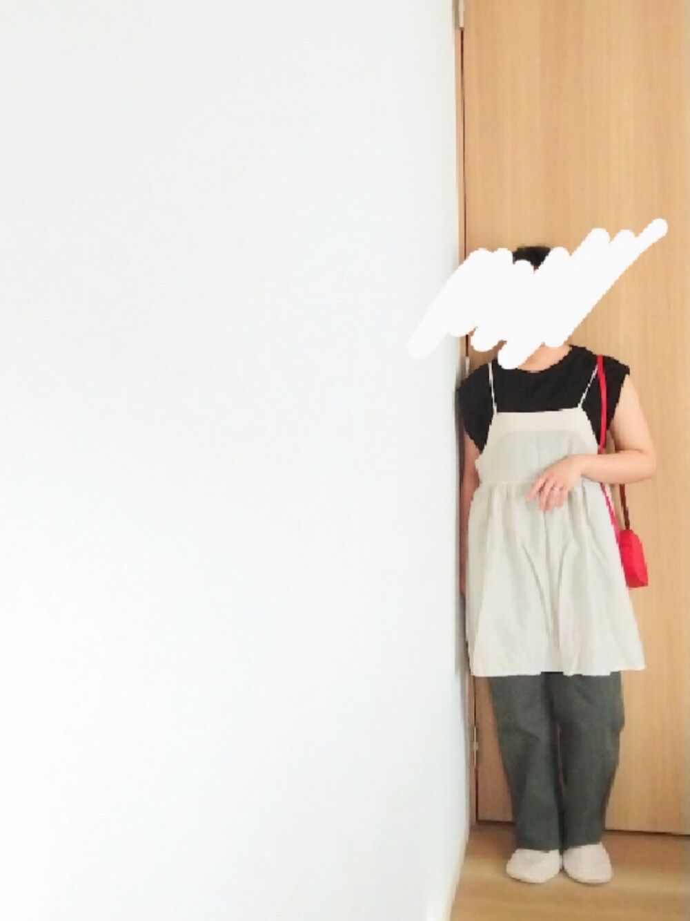 ホワイト系のチュニック、ブラック系のタンクトップ、グレー系のデニムパンツを着用したレディースの秋コーディネートの2枚目の写真