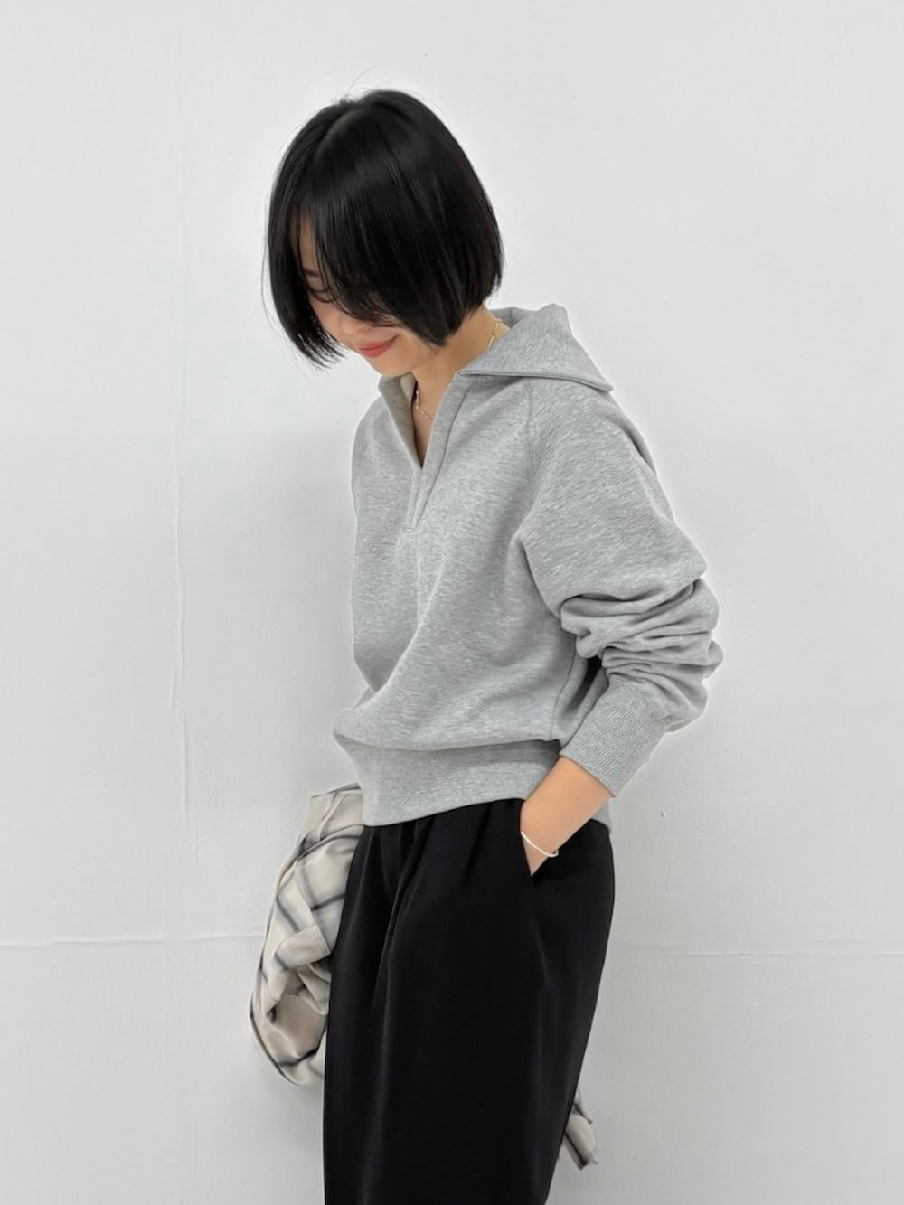 グレー系のスウェット、ホワイト系のシャツ/ブラウス、ブラック系のその他パンツを着用したレディースの冬コーディネートの2枚目の写真