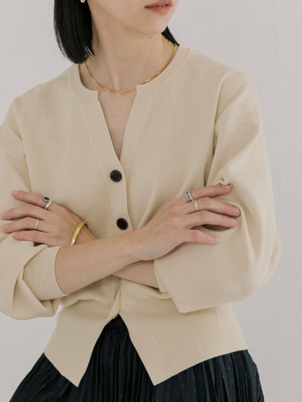 ホワイト系のカーディガン/ボレロ、ブラック系のスカートを着用したレディースの冬コーディネートの3枚目の写真