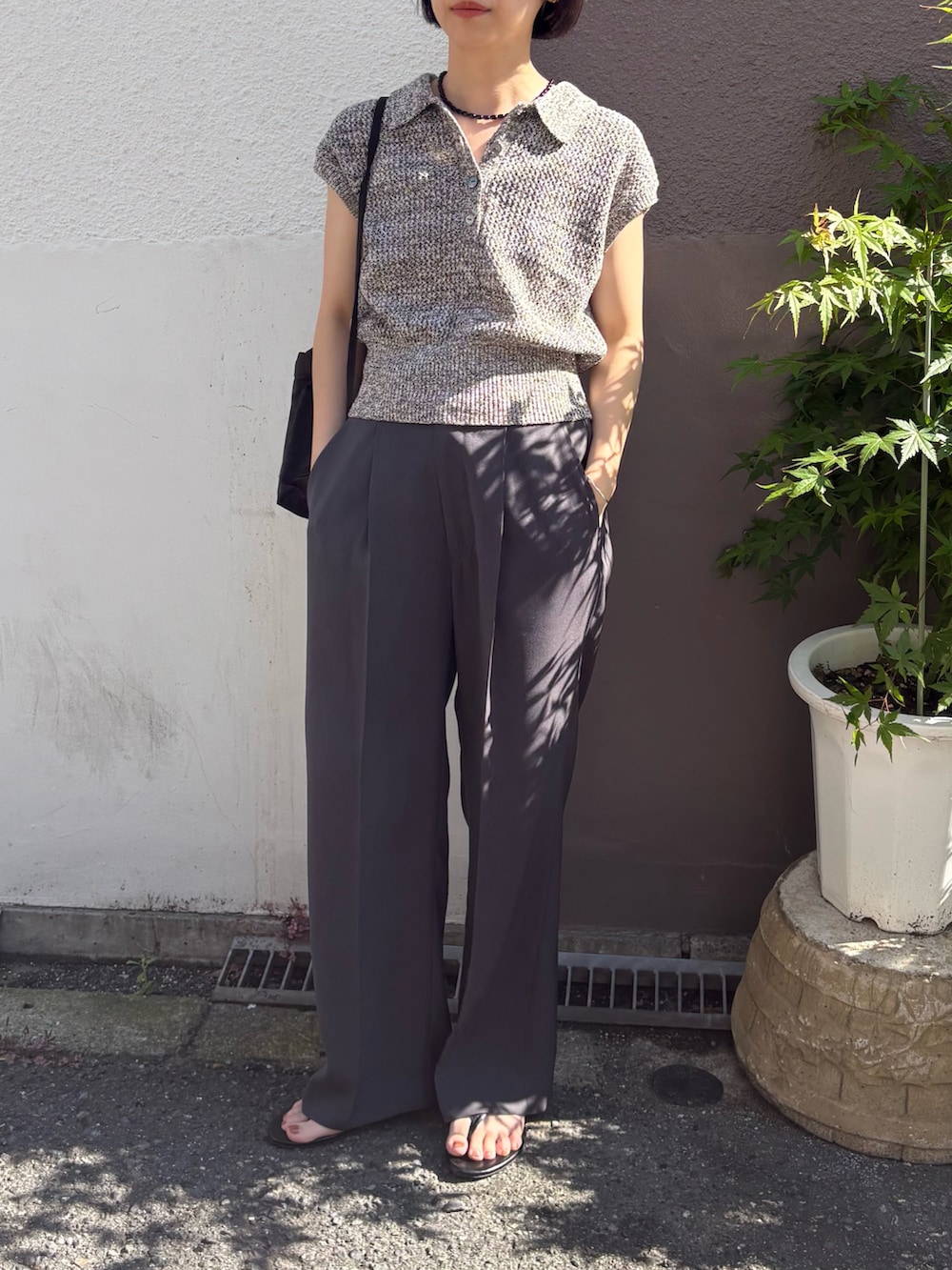 ブラック系のサンダル、グレー系のその他パンツ、ブラック系のバックパック/リュックを着用したレディースの夏コーディネートの2枚目の写真