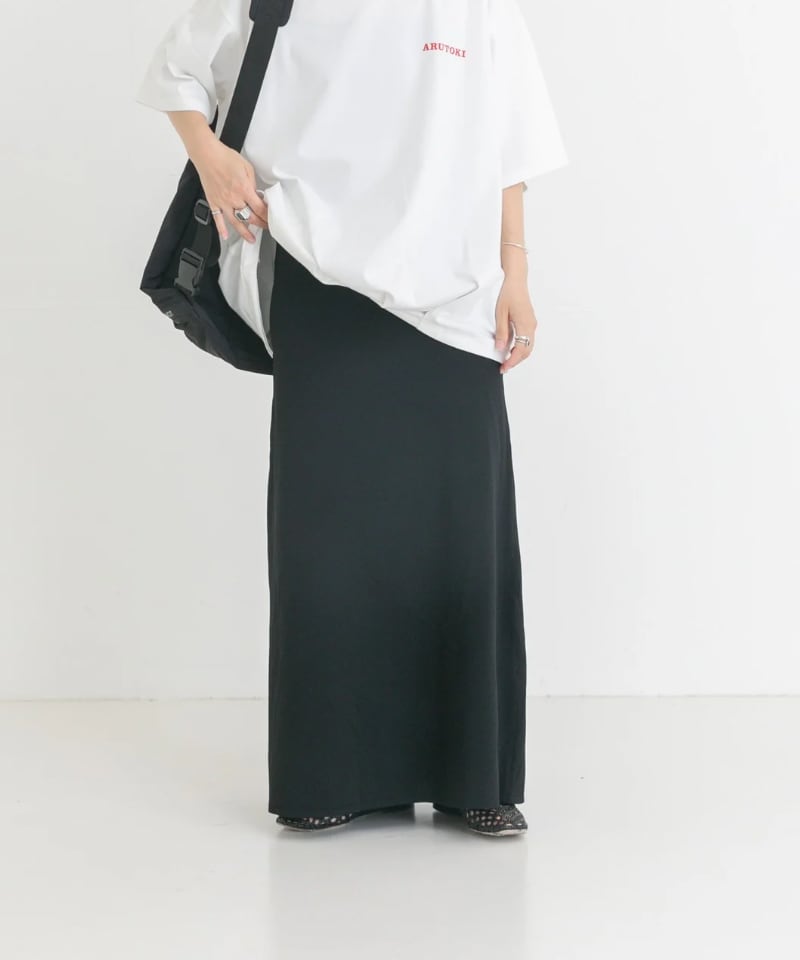 ブラック系のスカート、ホワイト系のTシャツ/カットソー、ブラック系のバックパック/リュックを着用したレディースの夏コーディネートの6枚目の写真